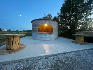 Converted grain bin with concrete pad