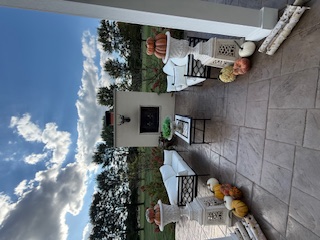 Outdoor fireplace patio with fall decorations