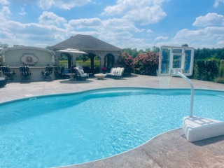 Pool area with pavilions on sunny day